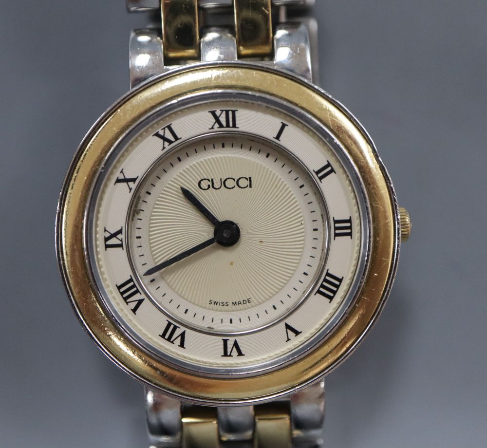 A ladys modern stainless steel and yellow metal Gucci quartz wrist watch, with original receipt and box(a.f.).